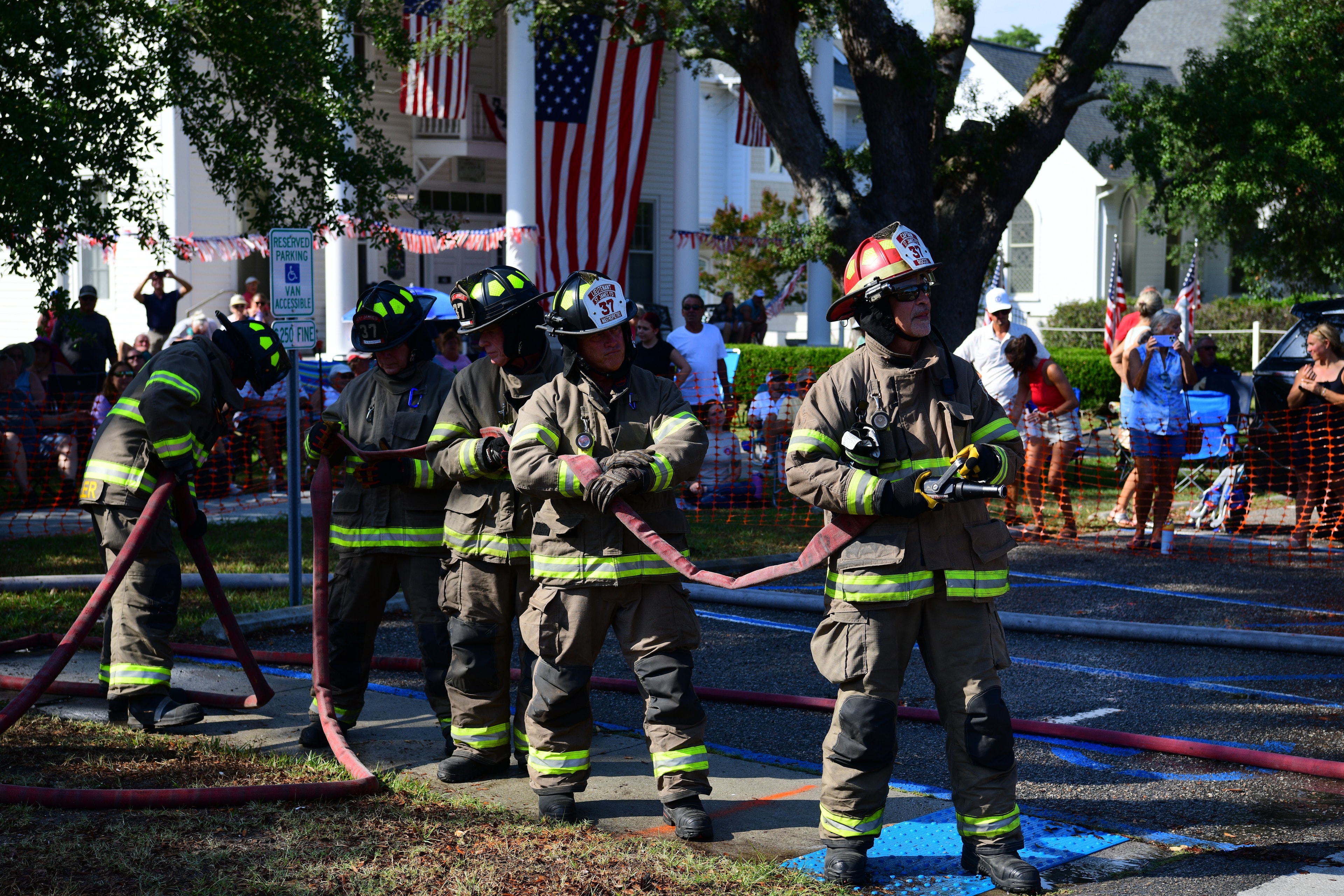 SJFD firefighters in turnout gear holding a charged hose line at the 2026 competition