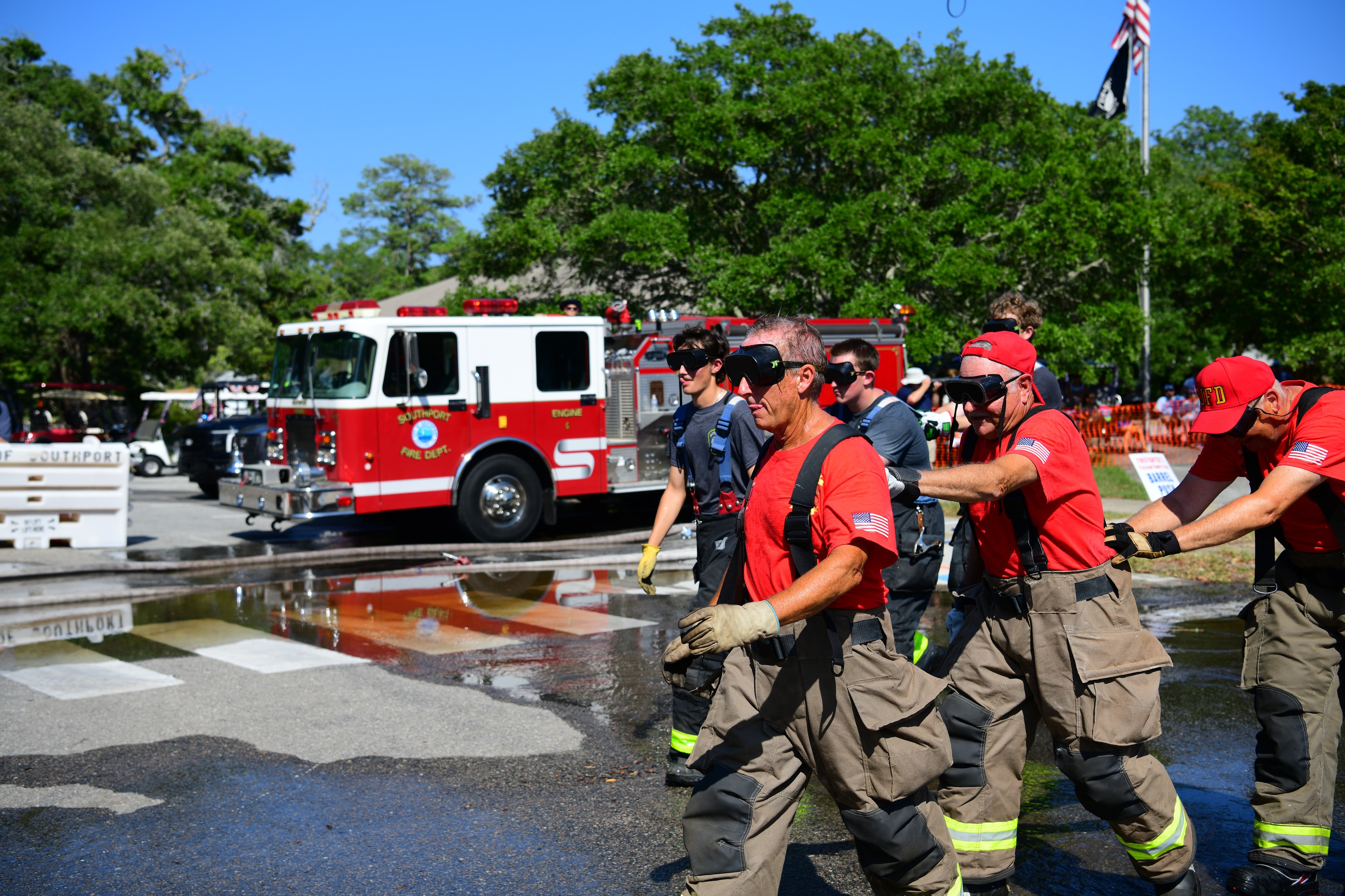 SJFD volunteers walking together after completing a competition event with a fire truck in the background
