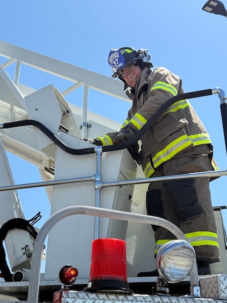 SJFD firefighter in full gear on the aerial ladder platform during the Dosher Wellness Center response