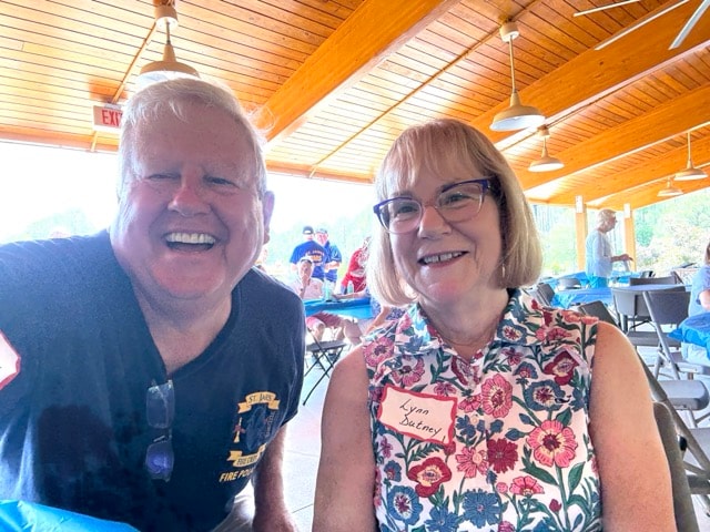 SJFD Fire Police volunteer and Lynn Dutney smile together at the picnic pavilion